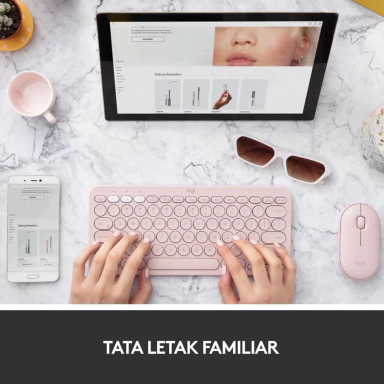 Tampilan Logitech K380 Multi-Device Keyboard di atas meja kerja, terhubung dengan laptop, tablet, dan smartphone melalui koneksi Bluetooth.